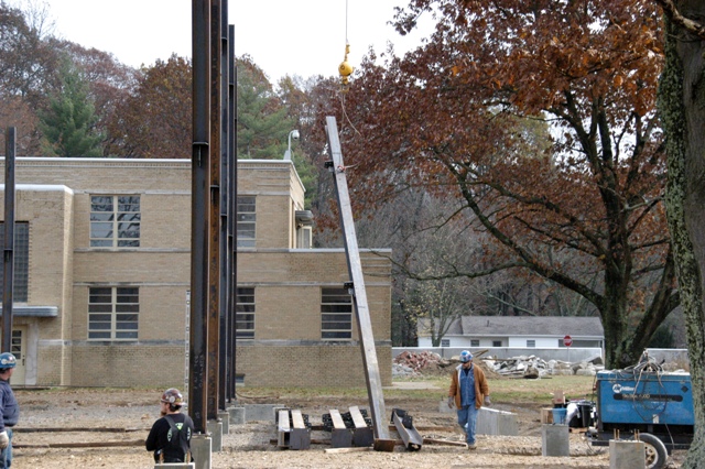 Construction workers install metal beams for one of the collasped structures at MUTC. U.S. Army photo, MUTC Public Affairs.